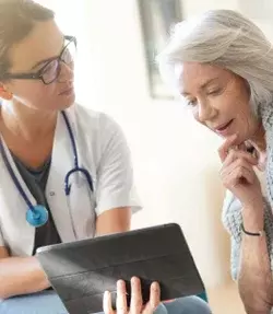 doctor and patient looking at tablet