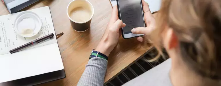 Woman checking email on a smartphone - Secure Email Gateway