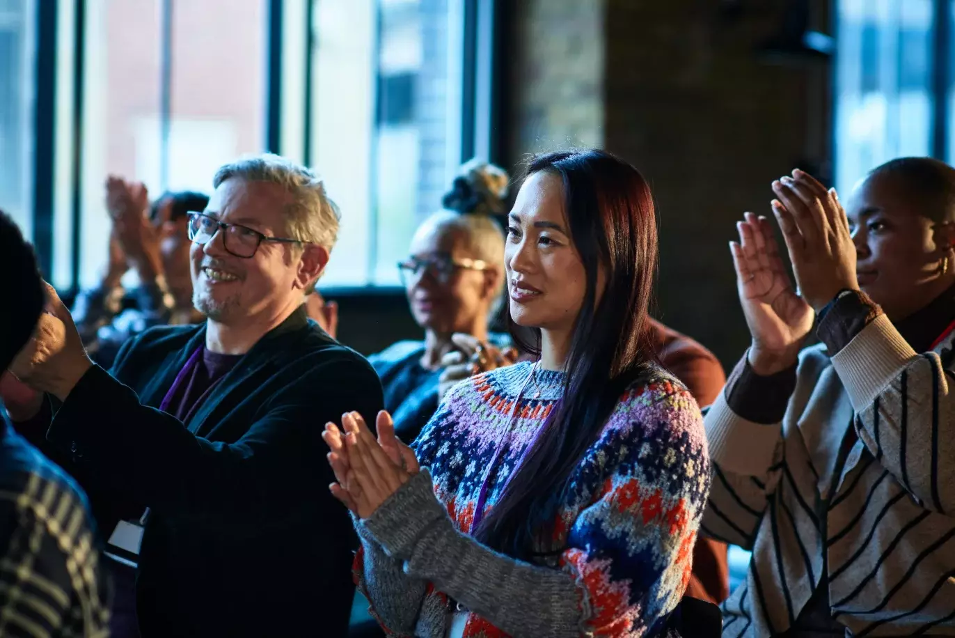 people at a conference clapping